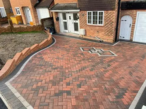 Brindle herringbone driveway with a grey border and a diamond feature by the front door