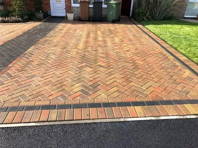 Brindle herringbone block paved driveway with a charcoal border and tarmac apron