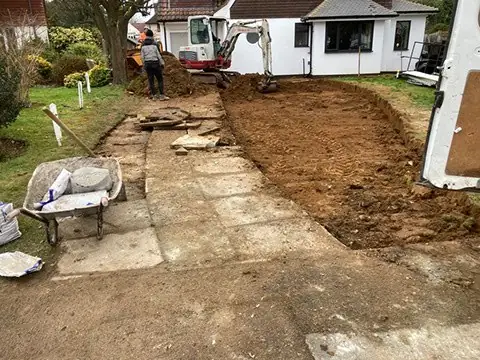 Old front garden paving dug out ready for a new driveway sub-base