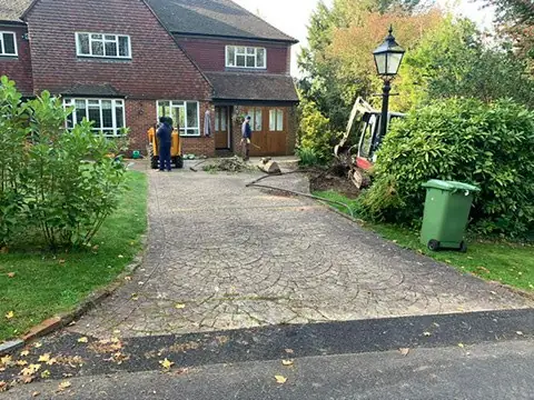 Old driveway being taken up during replacement, with the team on site