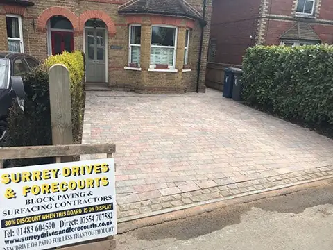 Paved front garden with a low brick wall and brick piers